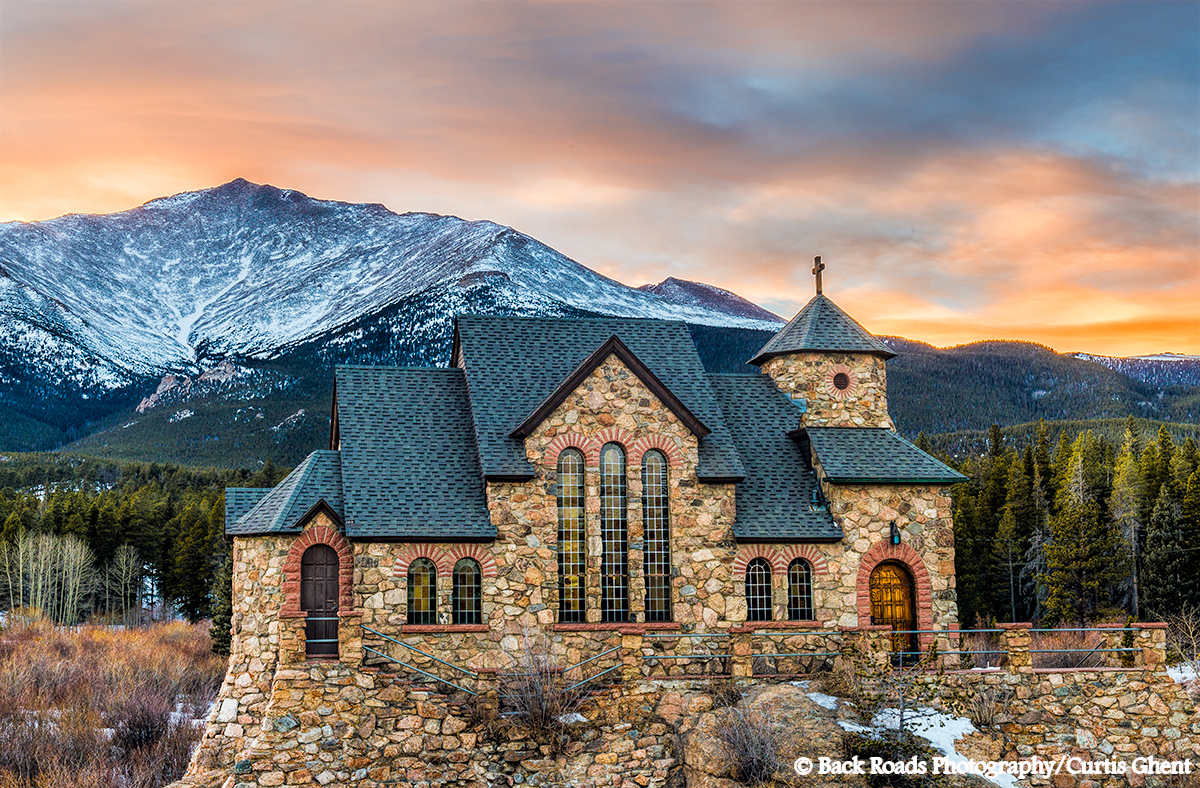 Colorful sunset over St. Malo, " Chapel on the Rock " with Mt. Meeker standing tall in the background.