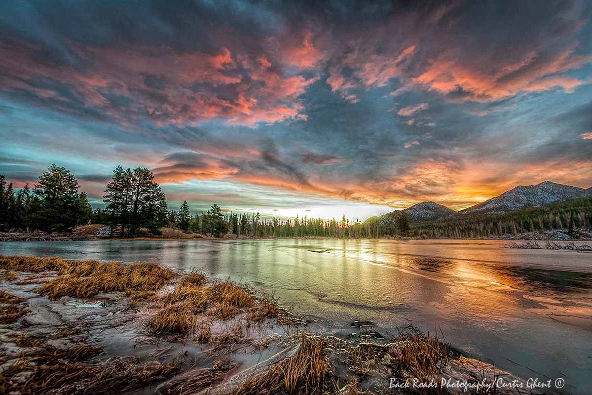 The ice on Sprauge Lake reflects a very colorful sunrise