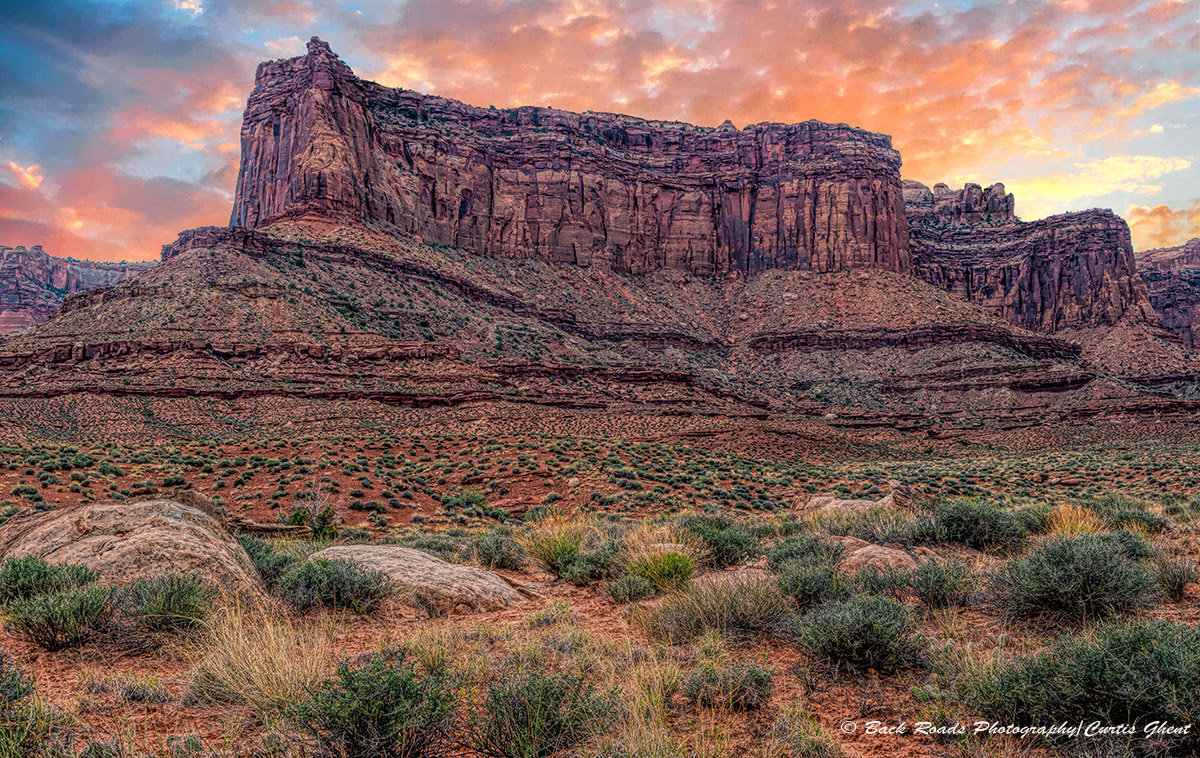 Colorful sunset clouds highlight one of the many buttes on the White Rim.